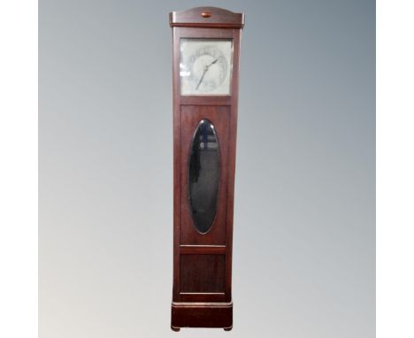 An early 20th century longcase clock with silvered dial 