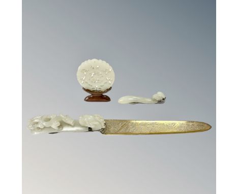 A Chinese carved jade disc on stand (diameter 55mm), together with two carved jade ruyi sceptres, one with carved dragon deta
