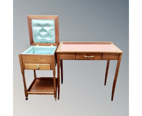 A mid century teak sewing table with a further writing table with a leather inset panel 