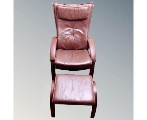 A Farstrup Mobler brown leather manual reclining armchair, with head rest and matching footstool 