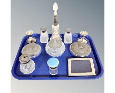 A group of cut glass dressing table bottles including several silver mounted examples, silver mounted easel photo frame, pair