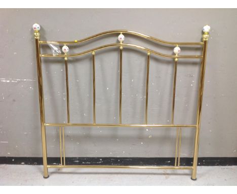 A brass and ceramic 4'6" headboard 