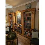A stained pine bookcase in George III style. The panelled centre section with a dentil-moulded