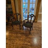 A pair of Victorian style mahogany armchairs having a shaped mahogany top rail and shaped carved