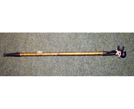 Oriental etched barrel opium pipe and a miniature bakelite example