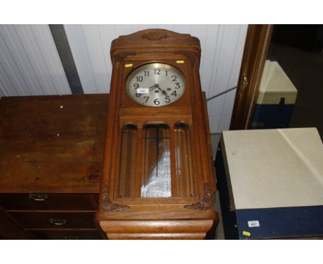 An early 20th Century oak cased chiming wall clock