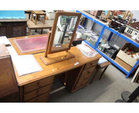 A pine pedestal dressing table fitted eight drawers and swing frame mirror