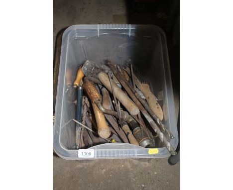 A box containing various hand tools to include drill bits, hand brace, mallets, wire brush etc