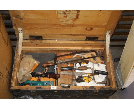 A wooden carpenters tool chest and contents of tools to include hand braces; hand saws; a circular saw drill attachments etc