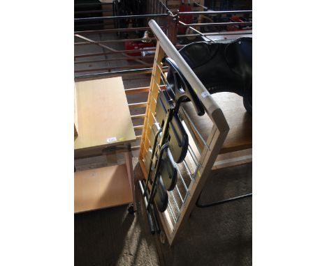 A wooden scissor effect rope strung clothes airer together with a folding three step set of steps