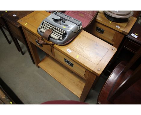 A light oak two drawer side table with under tier