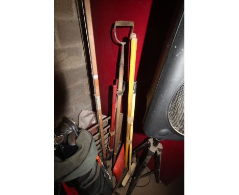 A quantity of long handled garden tools to include rake; long arm pruner, hoe etc