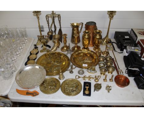 A collection of various brass ware including Art Deco style candlesticks, baluster vases, wall plaques etc. 