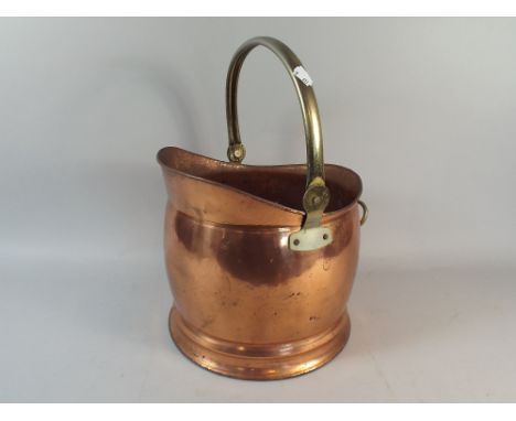 A Copper and Brass Helmet Shaped Coal Scuttle