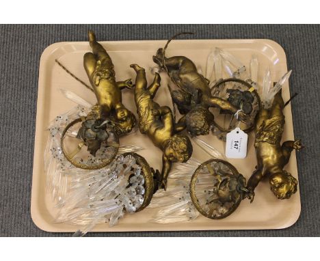 A set of four gilt cherub light fittings