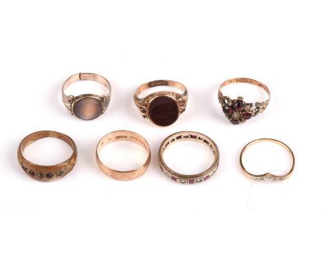 A selection of rings, including a carnelian signet ring, hallmarked Birmingham 1975, size J, a 5.7mm wedding band, size M, a 