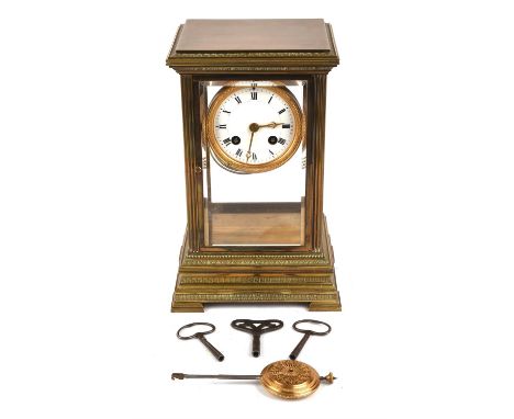 A French early 20th century brass mantel clock, with a 8in white enamel dial with Roman numerals, the eight day twin train mo