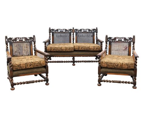 An English walnut and caned three piece bergere suite, in the William and Mary style,1930s, with loose seat and back cushions