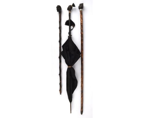 A hardwood parasol, 20th Century, with a finial carved in the form of an African native lady, 85cm high, together with two wa