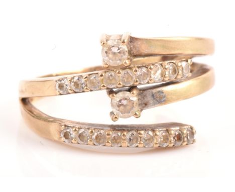 A cubic zirconia set crossover ring, mounted in stamped 9 ct, ring size R Condition Report:  Gross weight 4.75gOne heavily ch