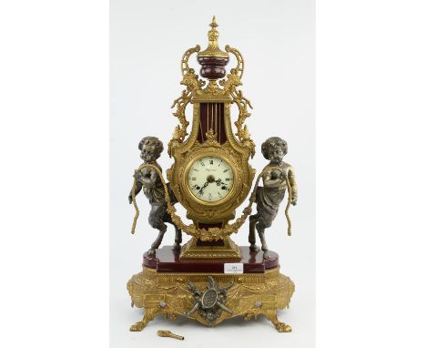 Louis XVI style gilt metal and burgundy porcelain mantel clock, 20th Century, with satyr mounts, the dial marked Imperial, 62