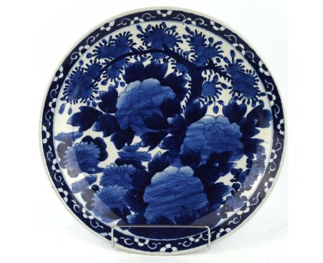 Chinese blue and white charger, late c19th/early 20th century, decorated with lotus flowers and fruiting trees, impressed sea