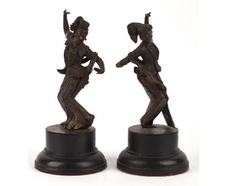 A pair of Balinese [or other South East Asian] bronze dancers; each one on a circular base; overall height 20 cm high (2)