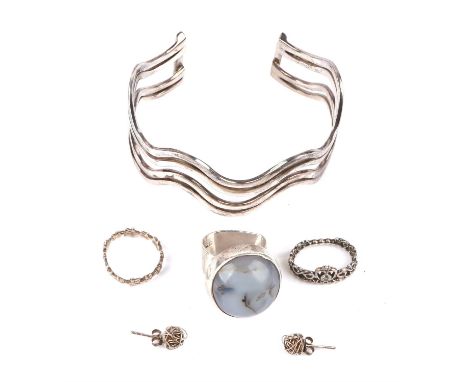 A selection of silver jewellery, including a cuff bangle, a gem set ring, a flower band ring, a pair of stud earrings and a P