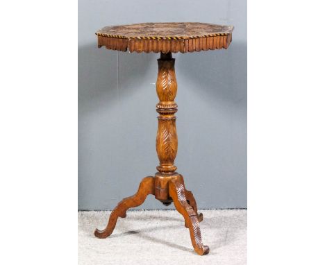 An unusual Victorian carved wood octagonal occasional table, the top carved with trailing fruiting vines and inlaid with circ