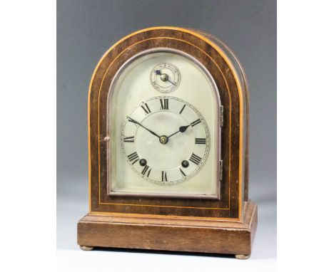 An early 20th Century German mahogany and bevelled glass cased mantel clock by Winterhalder &amp; Hofmeier,  the arched silve