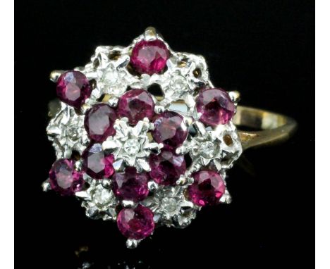 A modern 9ct gold mounted diamond and ruby cluster ring of flowerhead pattern, set with seven small brilliant cut diamonds an