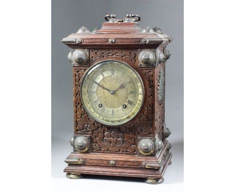 A late 19th Century German oak and brass mounted cased mantel clock by Winterhalder &amp; Hofmeier, the 4.75ins diameter gilt