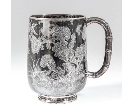 A Chinese silvery metal tankard engraved with bamboo shoots, flowering branches and insects, with C-scroll bamboo pattern han