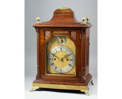 A late 19th Century mahogany and brass mounted mantel clock retailed by A. &amp; H. Rowley of London, the shaped gilt brass d