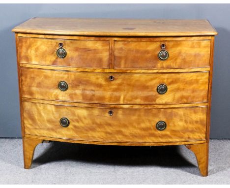 A Victorian satinwood bow front chest with moulded edge to top, fitted two short and two long drawers with later brass ring h