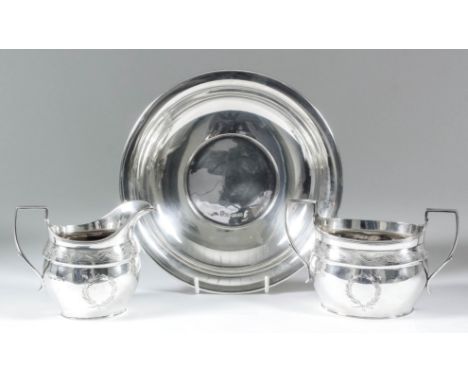 An Elizabeth II silver oval two-handled sugar basin with reeded mounts, engraved with a band of stylised leaf ornament and ci