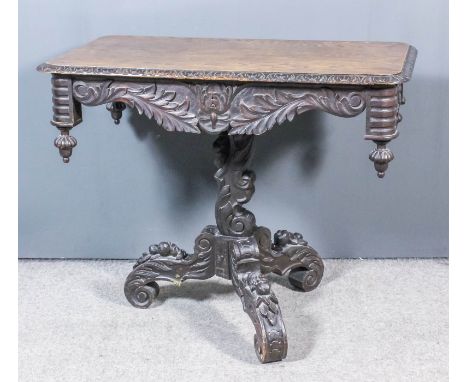 A Victorian "black oak" rectangular occasional table with leaf carved edge to top, shaped and carved apron with turned and re