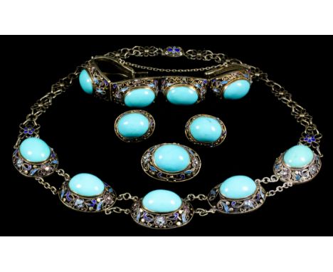 A gilt metal and enamel suite, set with oval turquoise cabochon stones within filigree and enamel borders, comprising - neckl