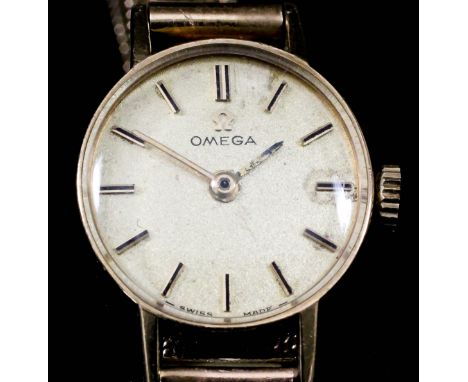 A lady's Omega 9ct gold cased wristwatch, the gold dial with gold and black baton numerals, 17mm diameter, on conforming Mila
