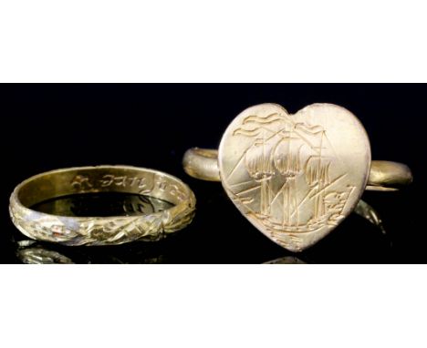 A 16th/17th Century gold coloured metal posy ring, the heart shaped face engraved with a ship, the interior of the band engra