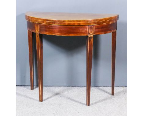 A George III mahogany D-shaped card table inlaid with rosewood bandings and stringings, with baize lined folding top, on squa