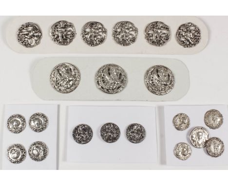 A set of six Edward VII silver circular buttons pierced and cast with cherubs playing a mandolin within scroll borders, 23mm 