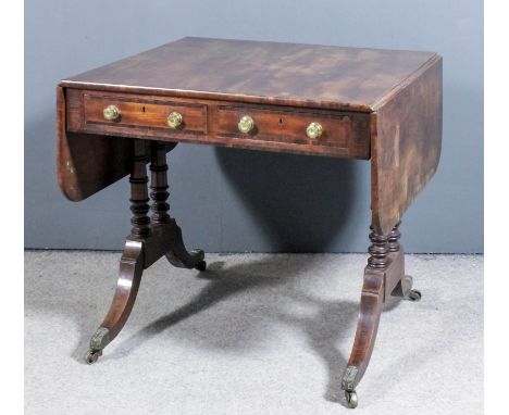 A George IV mahogany rectangular sofa table crossbanded in rosewood, fitted two real and two dummy frieze drawers, on twin tu