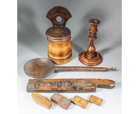 A turned olivewood candlestick of early 18th Century design, 9.25ins high, a turned wooden stave-built wall hanging salt box 