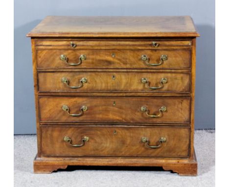 A mahogany chest of "George III" design with crossbanded top and moulded edge, fitted with a brushing slide and four long gra