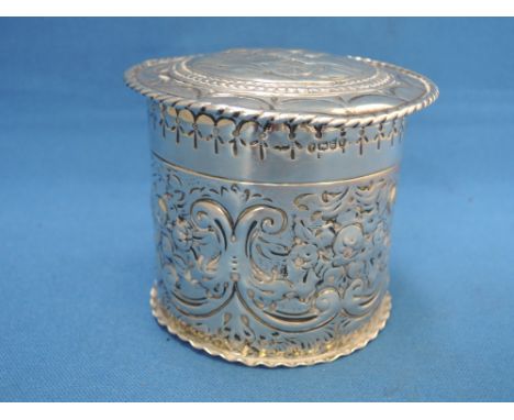 A silver trinket box of cylindrical form having horse and cart pictorial decoration to lid and swag and foliate decoration to