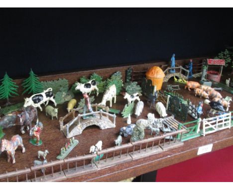 A shelf of Britains and similar lead farm animals, workers and accessories eetc