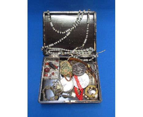 A lacquered box containing a selection of costume jewellery including a diamante hair comb, hat pin, pocket watch,  crystal b