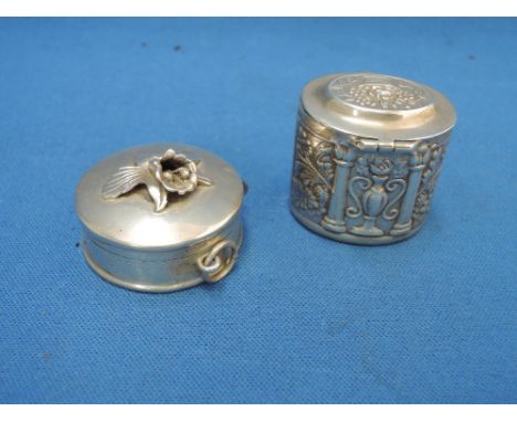 A small white metal trinket box stamped 925 having repousse foliate decoration and a hinged lid, and a white metal cased retr