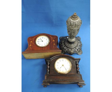 An Edwardian mahogany mantel clock having chequered and foliate line inlay decoration, a 1920's oak mantel clock having twist